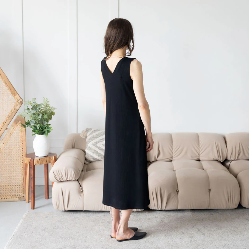 Woman in black sleeveless dress, July 25 screenshot.