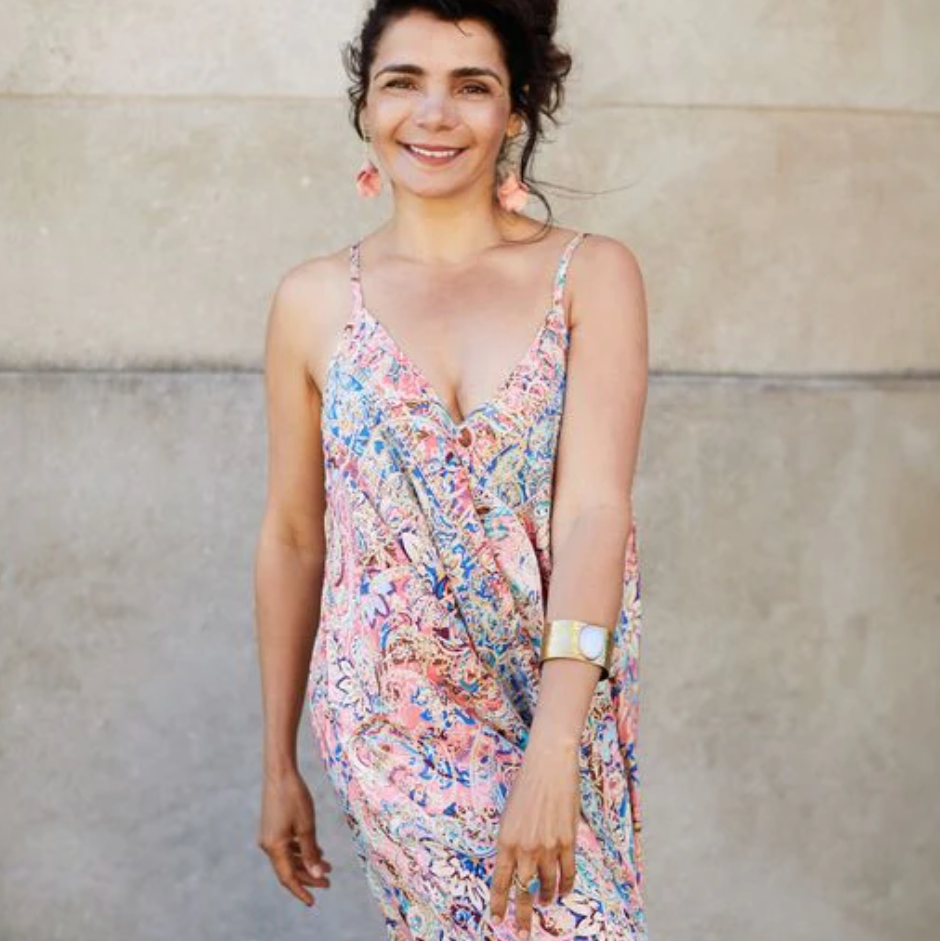 Woman in colorful dress, screenshot Aug 16, 2025