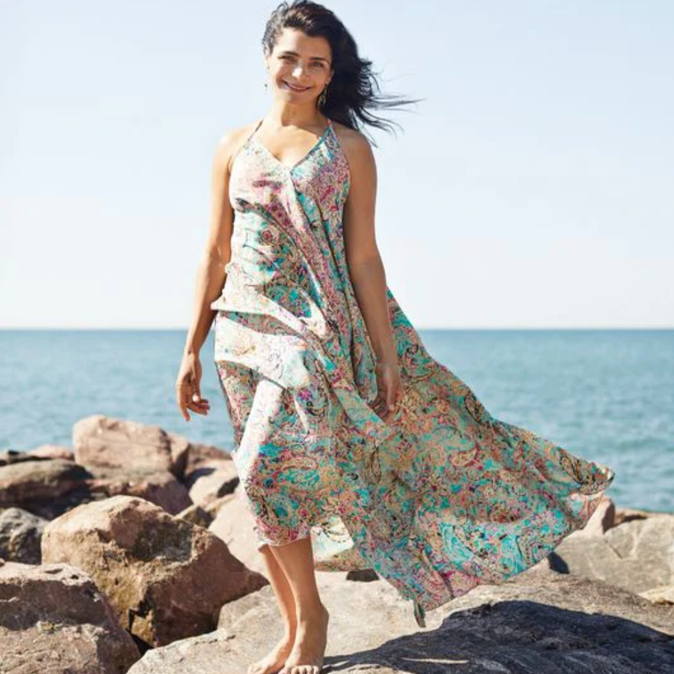 Woman in flowing dress by the ocean, August 16, 2025 screenshot.