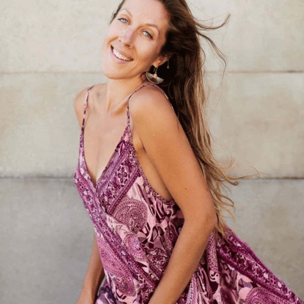 Smiling woman in patterned dress, Aug 16 screenshot.