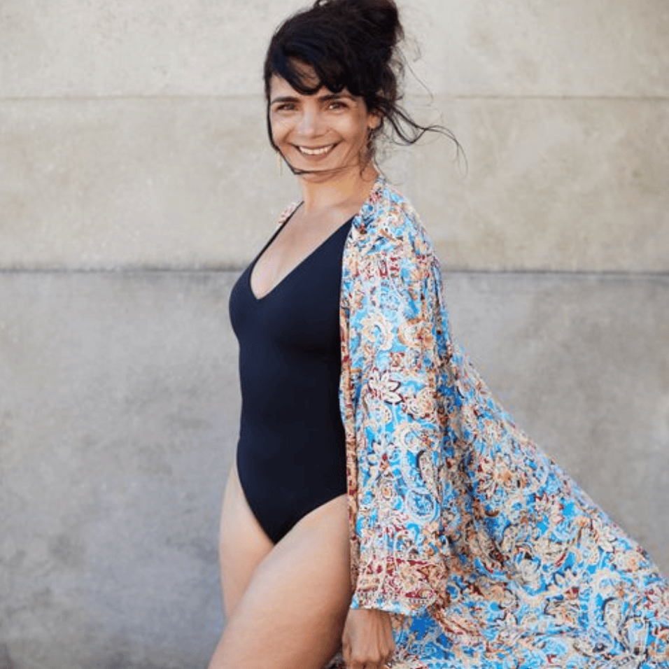 Woman in swimsuit and colorful robe, August 16 screenshot.