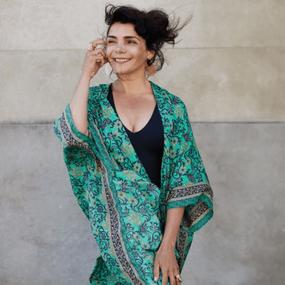 Woman in green patterned kimono, screenshot August 16, 2025.