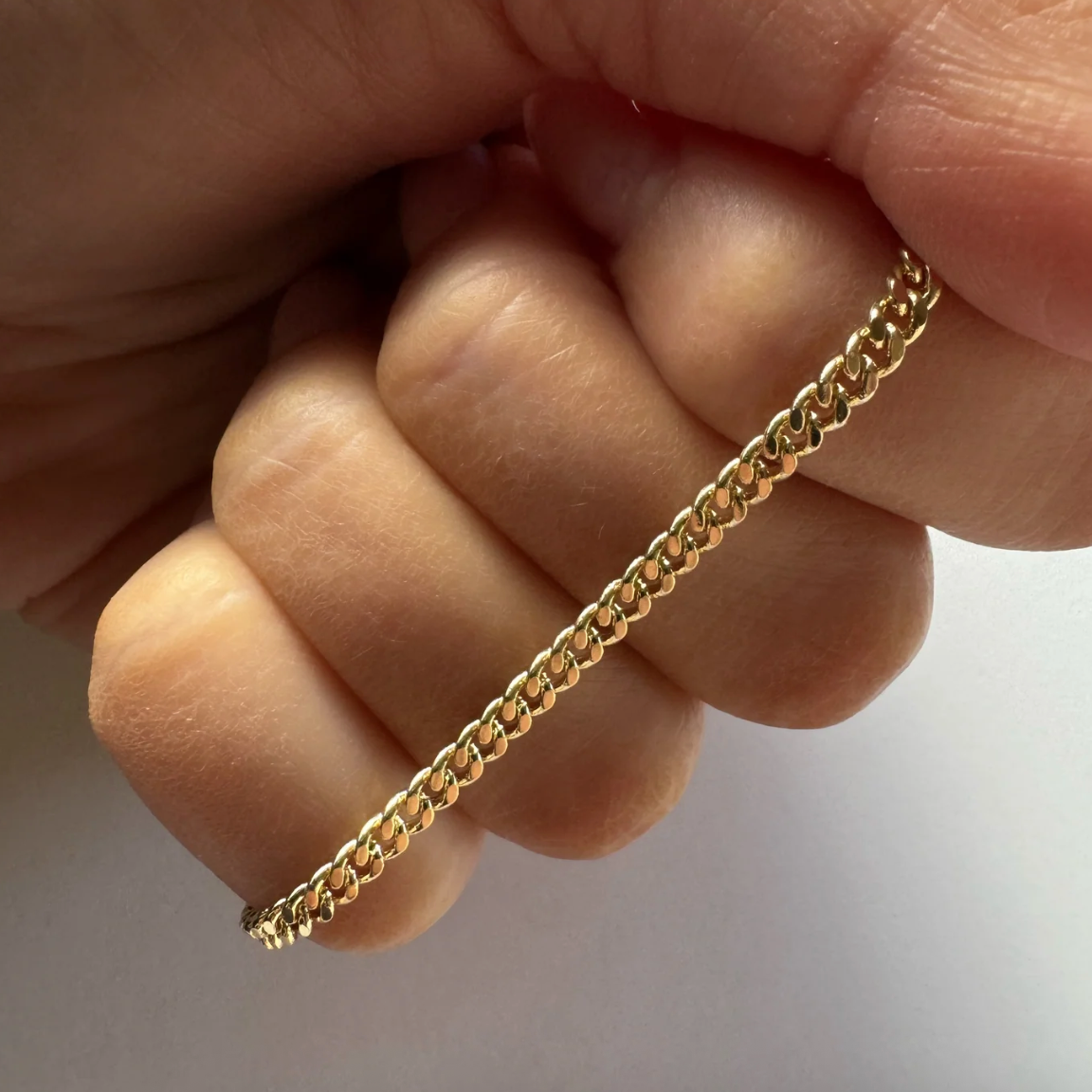 Gold chain bracelet held in hand, August 22, 2025 screenshot