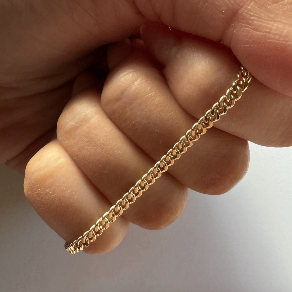 Gold chain bracelet held in hand, August 22, 2025 screenshot