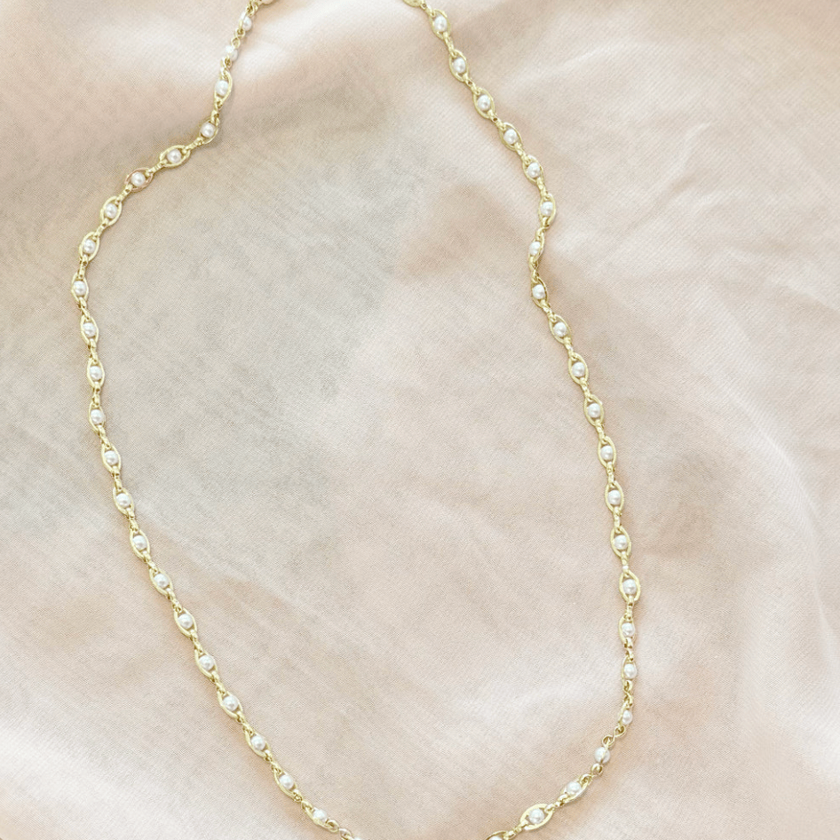 Gold necklace with small pearls, screenshot from August 22, 2025.