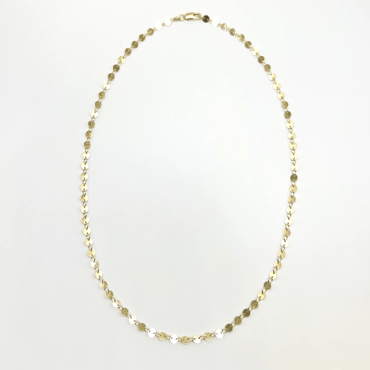 Gold disc necklace, screenshot from August 22, 2025
