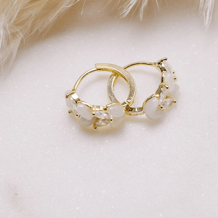 Gold hoop earrings with white stones, screenshot from Aug 22, 2025