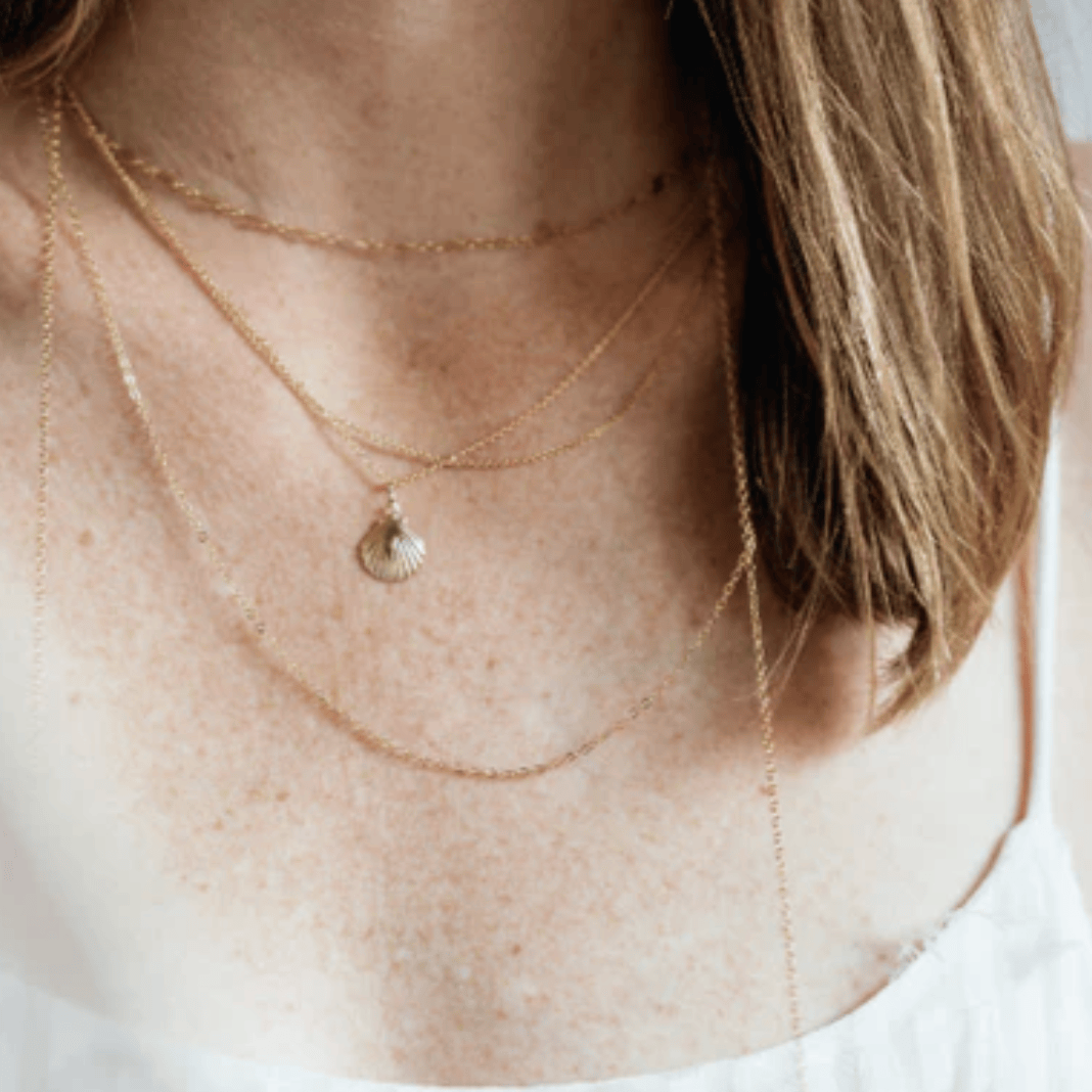 Gold necklaces on a woman's neck, screenshot Aug 27, 2025.