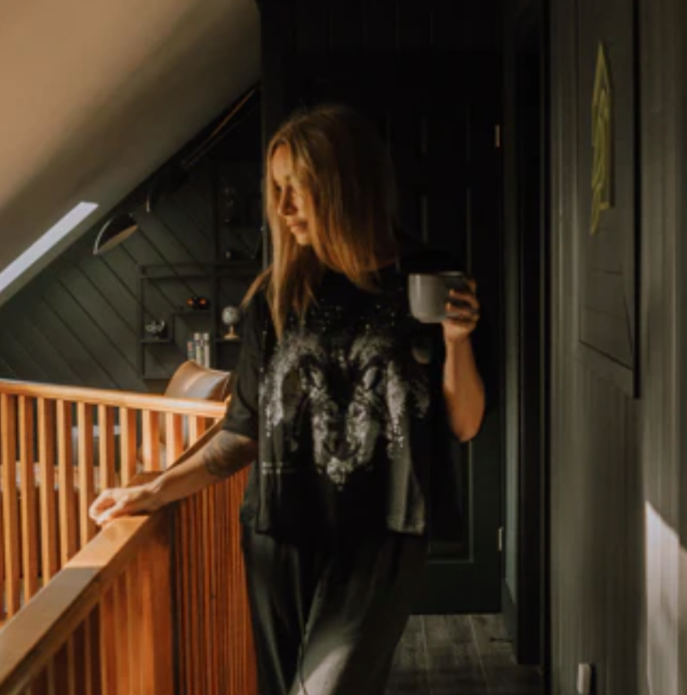 Woman on balcony with coffee, Sept 11, 2025 screenshot.