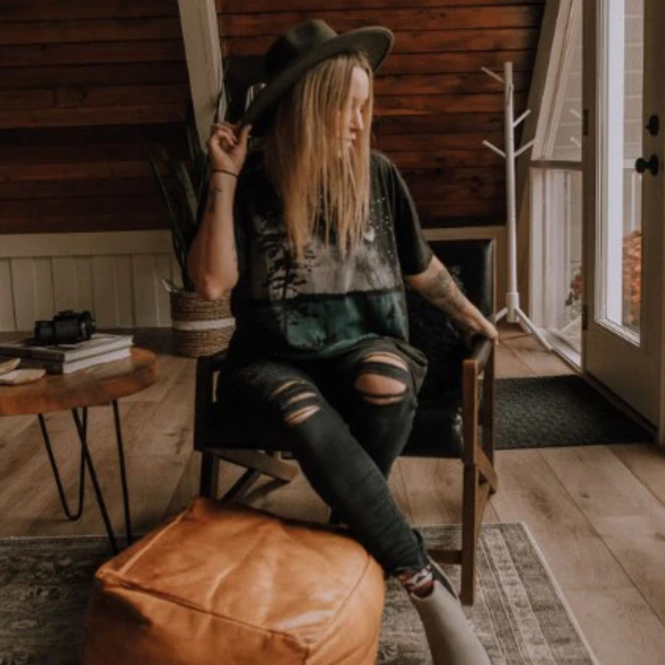 Woman in hat sitting indoors, September 12, 2025 screenshot.