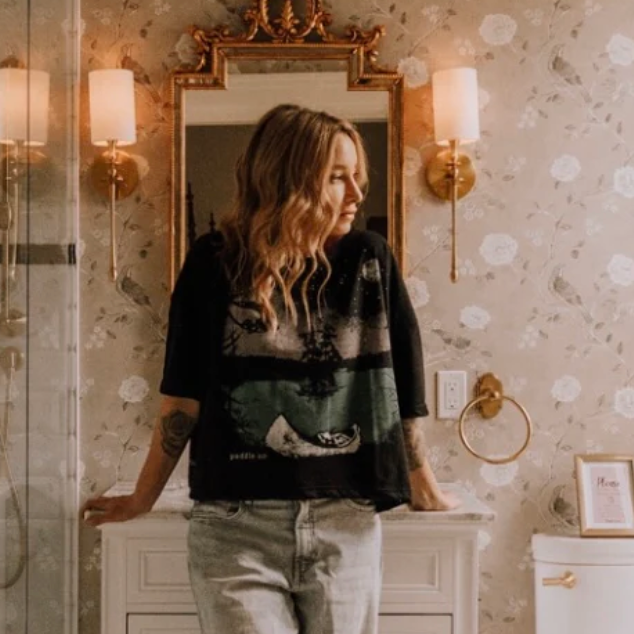 Woman in bathroom with mirror, September 12, 2025 screenshot.