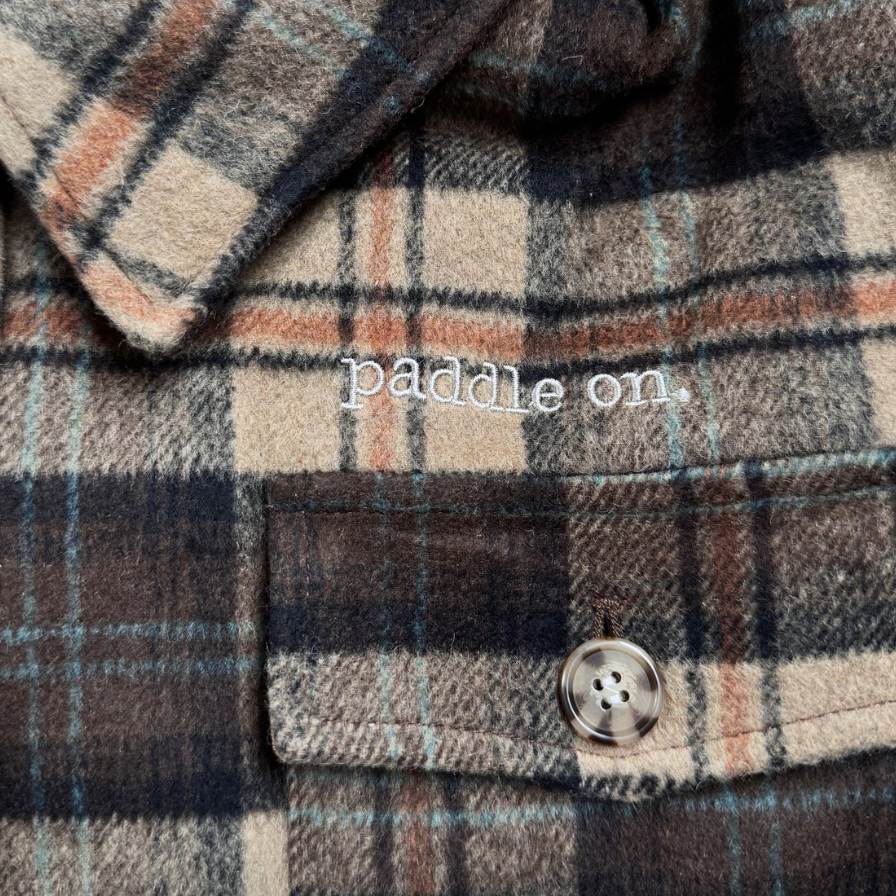 Plaid shirt with paddle on embroidery, screenshot from 2025.