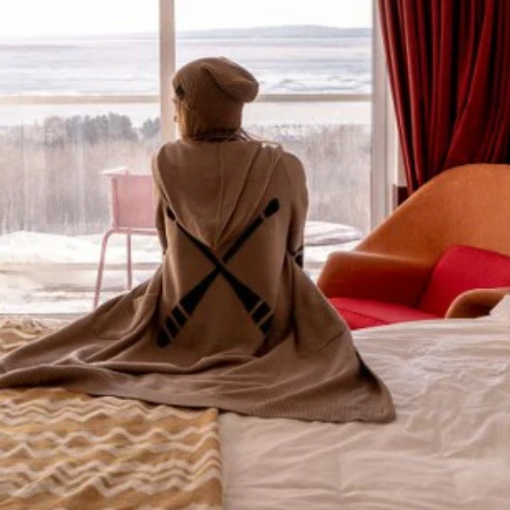 Woman in coat looking at the ocean, Sept 12, 2025 screenshot.