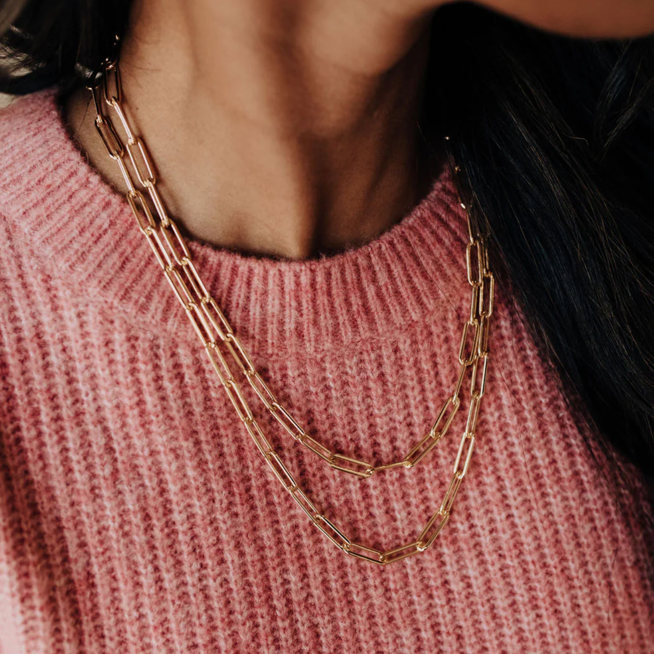 Gold chain necklace on pink sweater, Sept 15 screenshot