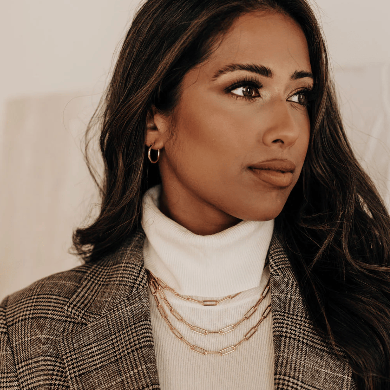 Woman in turtleneck and blazer, screenshot Sept 15, 2025.