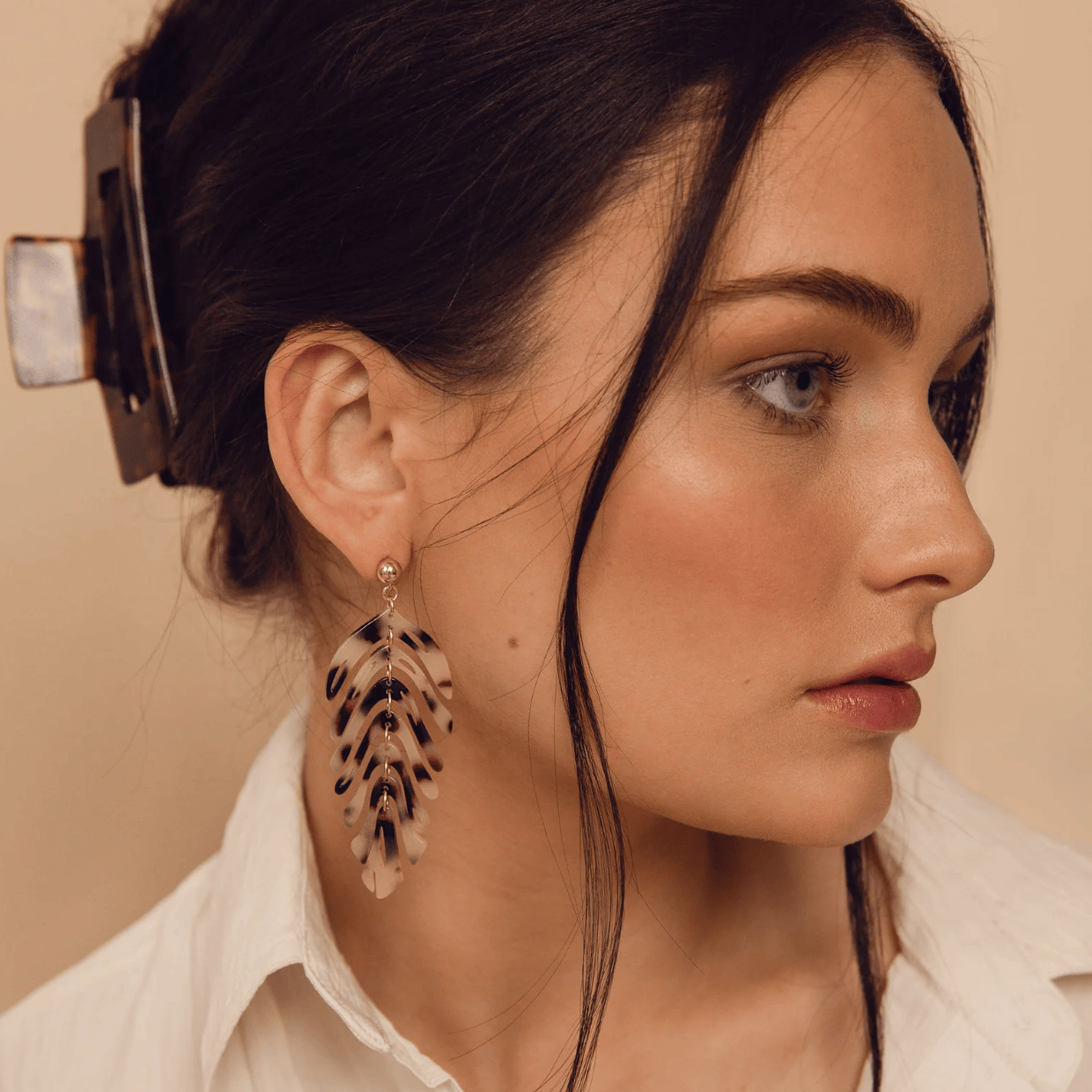 Woman wearing leaf earrings, screenshot from Sept 15, 2025
