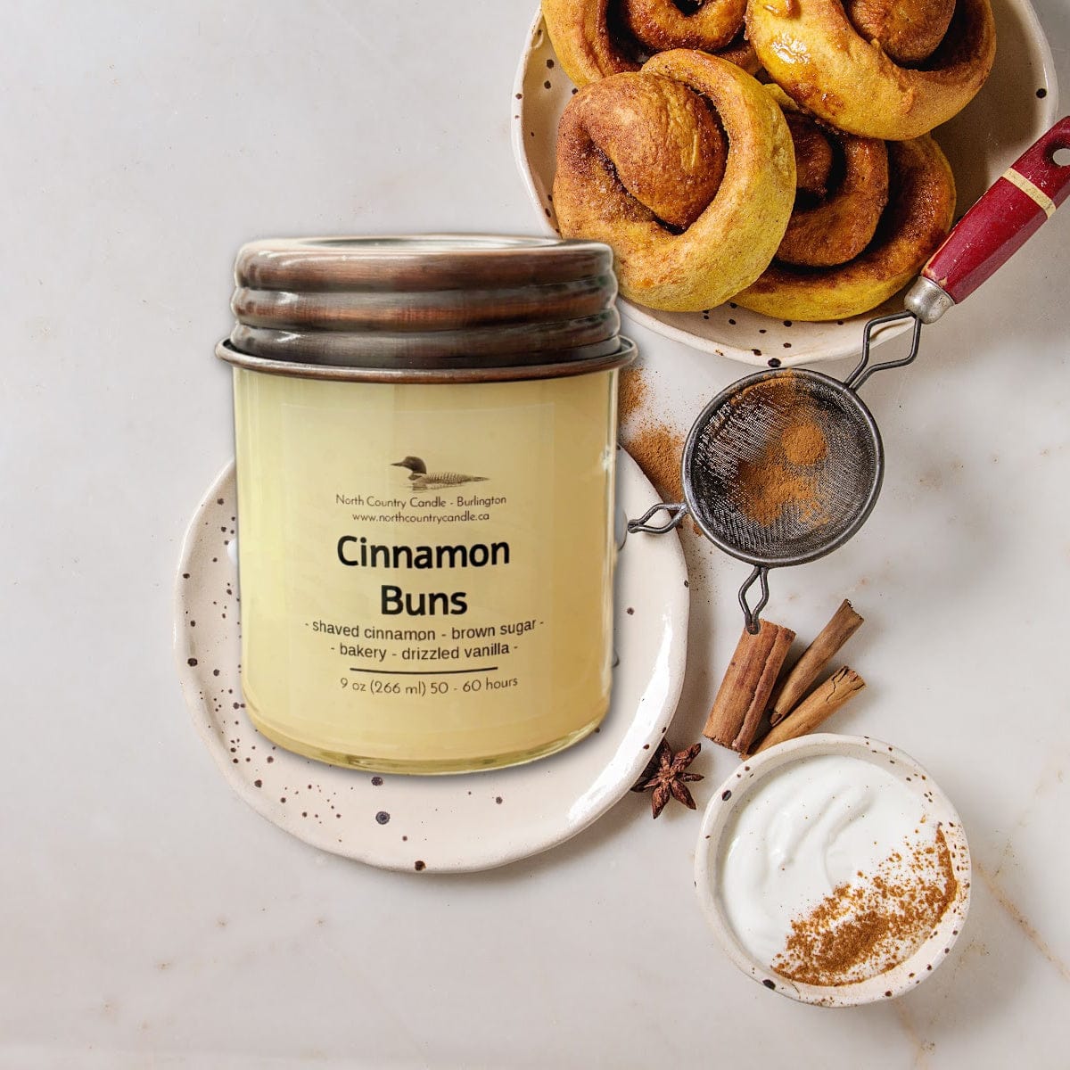 Cinnamon Buns candle with fresh cinnamon rolls and ingredients.