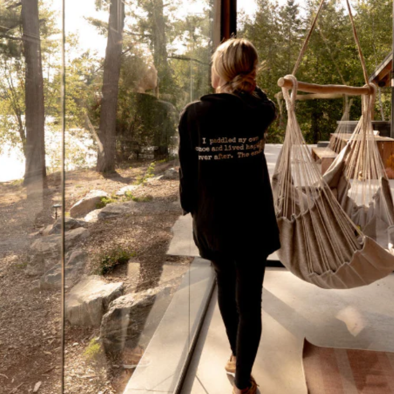 Woman in black hoodie by window, screenshot Sept 18, 2025