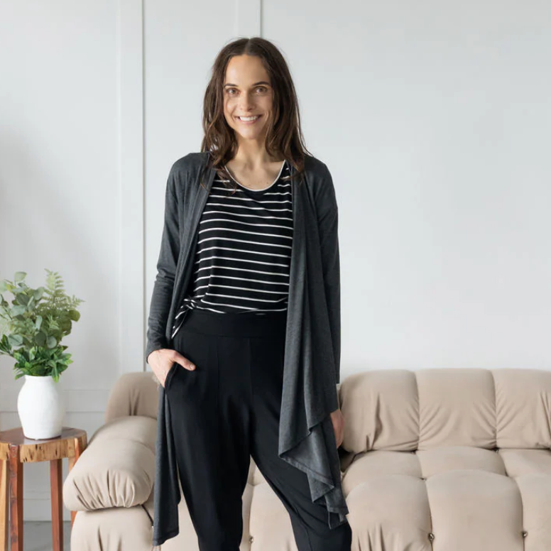 Woman wearing dark grey cardigan and black outfit, Sept 16 screenshot